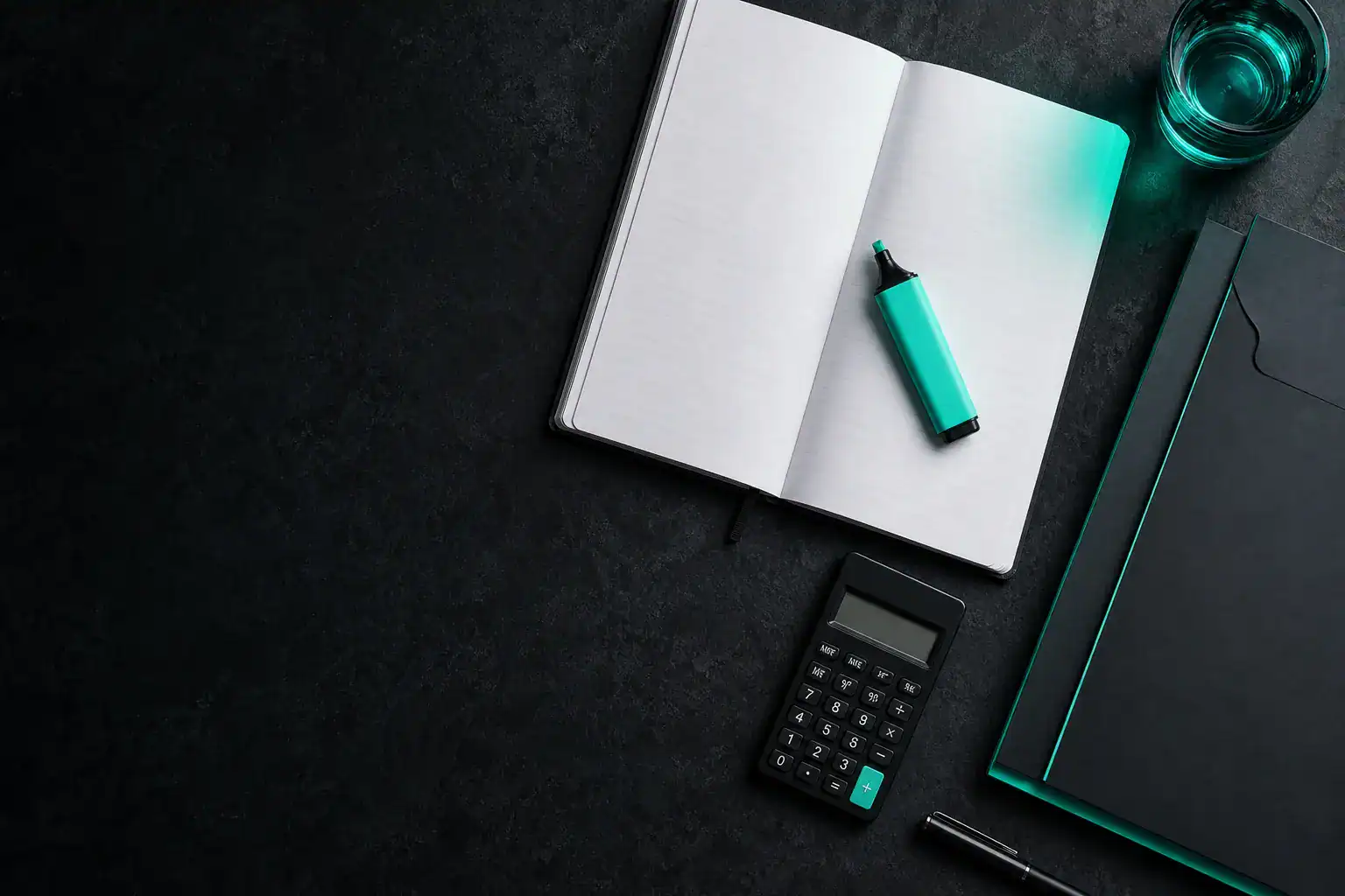Open notebook with calculator and teal stationery